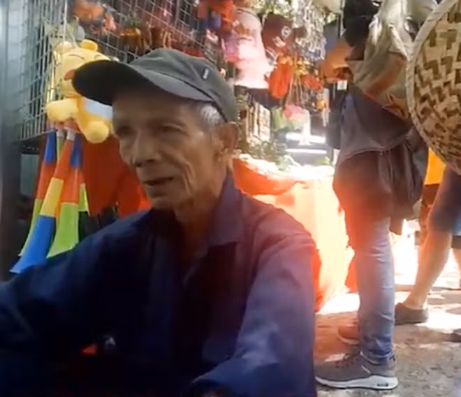 Ông Tài ngồi nghỉ giữa chặng đường lên núi.