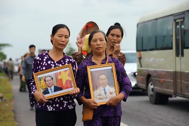 Cùng với dòng người vội vã về Quang Thiện trưa nay, hình ảnh khiến nhiều người không khỏi xúc động khi những bức di ảnh của Chủ tịch nước Trần Đại Quang được người dân mang theo bên mình. Đây là tình cảm của người dân Ninh Bình đón "người con" về với đất mẹ