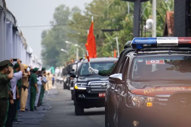 Dọc tuyến đường đoàn tang lễ đi qua, nhiều người dân đứng chào đón, vẫy tay tiễn biệt