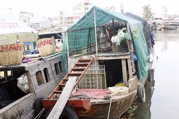 Chiếc thuyền đơn sơ dãi nắng dầm mưa của vợ chồng anh Hường.