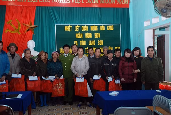 Đại tá Hà Văn Thể, Trưởng ban Kinh tế- văn hóa- xã hội Báo CAND; đại diện Ngân hàng BIDV; đại diện Công an tỉnh Lạng Sơn và Công an huyện Lộc Bình trao tặng quà Tết người nghèo xã Nam Quan.
