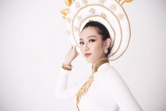 Cùng chiếc mấn lấy Hoa Sen làm chủ đề, NTK Việt Hùng chia sẻ: "Hoa Sen vàng chiếu sáng lung linh được những người thợ thủ công cần mẫn đắp nối tạo hiệu ứng 3D cùng hàng trăm hạt phale kết bằng tay tỉ mỉ ngày đêm".
