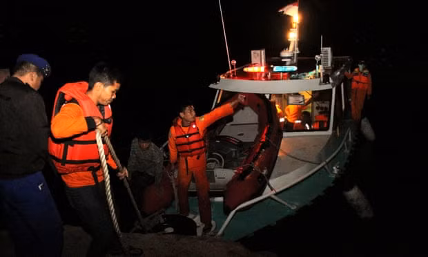 Nhân viên cứu hộ tìm kiếm các nạn nhân trong đêm tại hồ Toba. Ảnh: Reuters