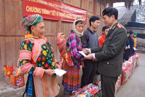 Đại diện Báo CAND và đại diện chính quyền, Công an huyện Quang Bình, Công an tỉnh Hà Giang tặng quà đồng bào nghèo xã Nà Khương.