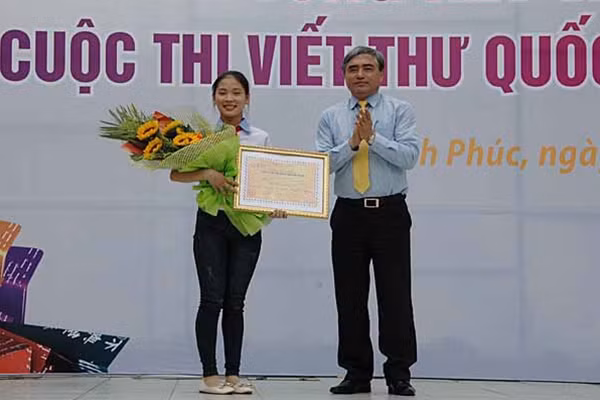 Thứ trưởng Bộ TT&TT Nguyễn Minh Hồng trao giải Nhất cuộc thi Viết thư Quốc tế UPU lần thứ 45 cho thí sinh Nguyễn Thị Thu Trang.