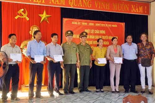 Trung tướng Lê Ngọc Nam, đại diện Báo CAND và Công ty CP Xây dựng Bắc Nam 79 trao tiền hỗ trợ xã Duy Nghĩa.