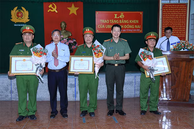 Đồng chí Cao Tiến Dũng, Chủ tịch UBND tỉnh và đồng chí Đại tá Vũ Hồng Văn, Giám đốc Công an tỉnh tặng bằng khen, hoa chúc mừng các cá nhân lập thành tích xuất sắc