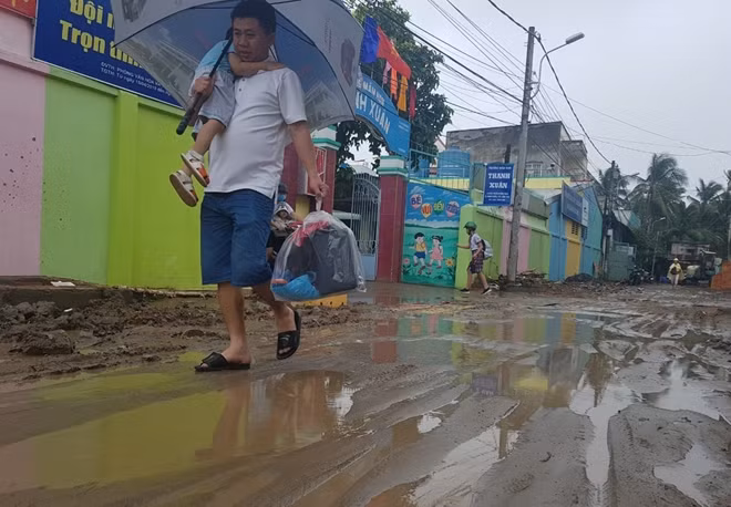 Nhiều phụ huynh phải đi bộ rước con trên con đường lầy lội, trơn trợt.