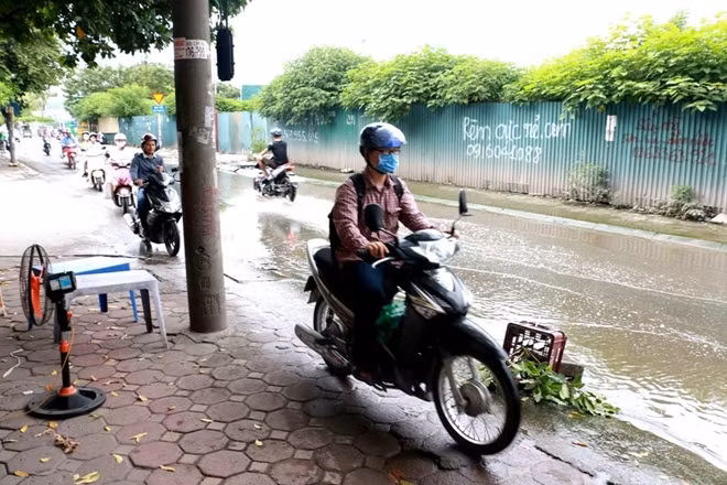 Nước ngập hết lòng đường nên nhiều người e sợ buộc phải cho phương tiện di chuyển trên hè phố.