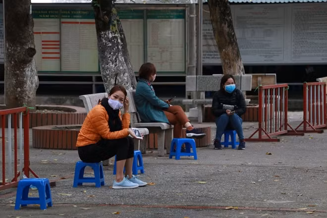 Người dân đến xét nghiệm được hướng dẫn ngồi cách xa nhau 1m để tránh lây nhiễm chéo.
