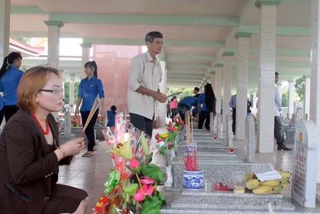 Chị Hân thắp hương tại Nghĩa trang liệt sĩ xã Vĩnh Hiền.