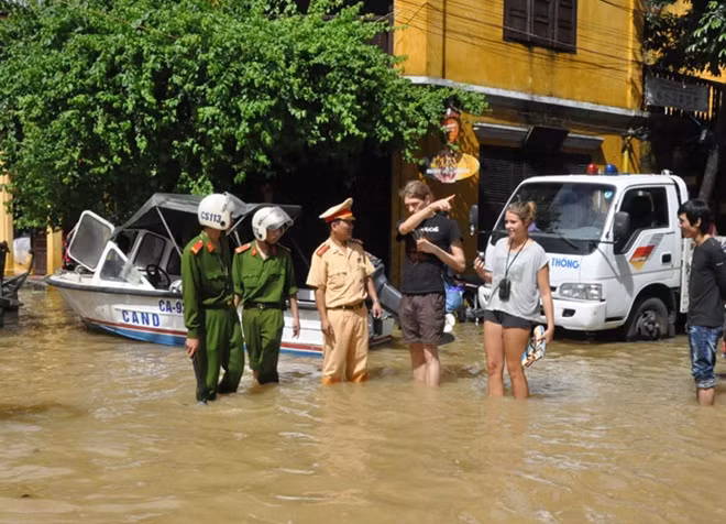 Tác phẩm: "An toàn cho du khách" - Công an TP Hội An, tỉnh Quảng Nam, dầm mình trong nước lũ hướng dẫn du khách nước ngoài không được đến các khu vực ngập lụt sâu trong phố cổ. Tác giả Văn Long(Đà Nẵng).