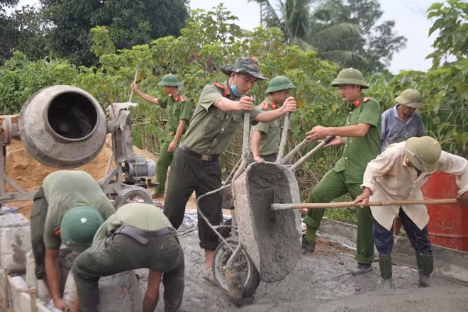 Lực lượng Công an cùng nhân dân làm đường.