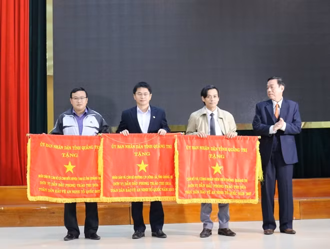 Đại diện chính quyền xã Cam Hiếu (ngoài cùng bên trái) nhận Cờ thi đua xuất sắc trong phong trào toàn dân BVANTQ năm 2017.