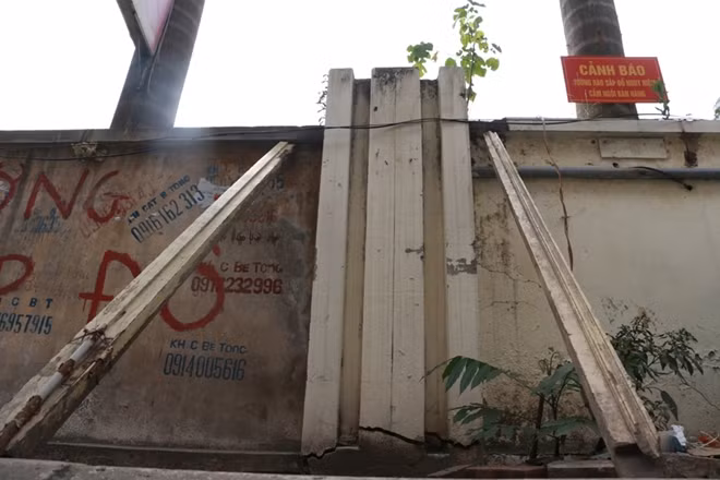 Theo bà Hoàng Thị Lý, một người dân tại khu vực này cho biết, bức tường đứng trước nguy cơ đổ sập từ cách đây 2 năm, tuy nhiên chỉ được chống bằng các thanh gỗ như thế này.