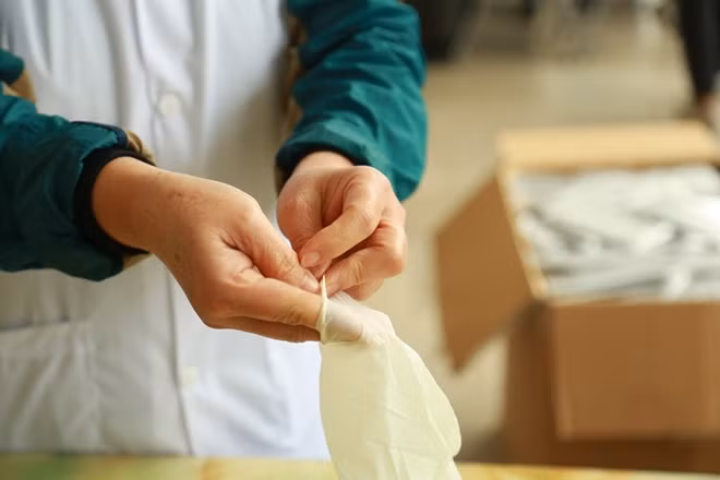 Mỗi thành viên của nhóm trước khi phát khẩu trang đều phát đeo găng tay để bảo vệ.