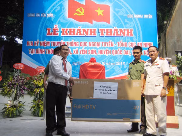 Đại diện Cục Ngoại tuyến tặng quà cho nhân dân thôn Ba Nhà, xã Yên Sơn.