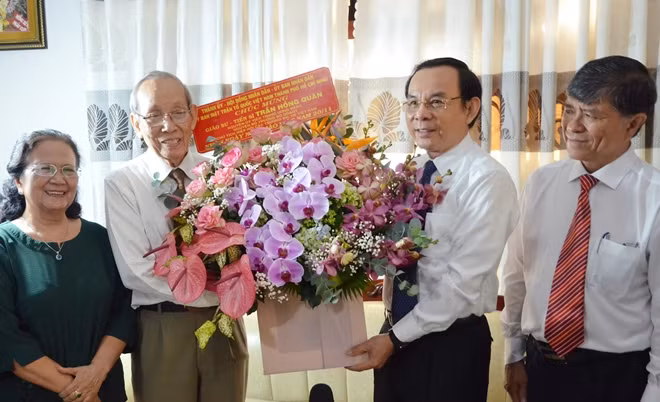 Bí thư Thành ủy TP Hồ Chí Minh Nguyễn Văn Nên tặng hoa Giáo sư, Tiến sĩ Trần Hồng Quân.
