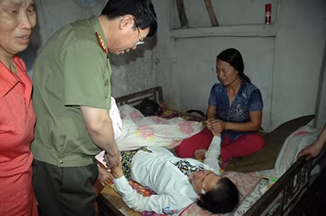 Thứ trưởng Bùi Văn Nam động viên bà Vĩnh thân sinh của đồng chí Trần Mạnh Tùng đang ngã bệnh vì hay tin con hy sinh.
