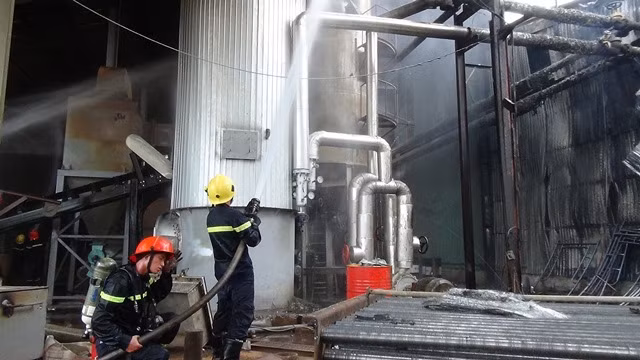 Các chiến sỹ Cảnh sát PCCC phun nước và hóa chất vào lò hơi