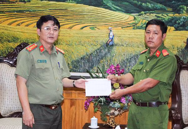 Đại diện Công an tỉnh Lai Châu trao số tiền 50 triệu đồng cho đồng chí Lý Phùy Chóng.