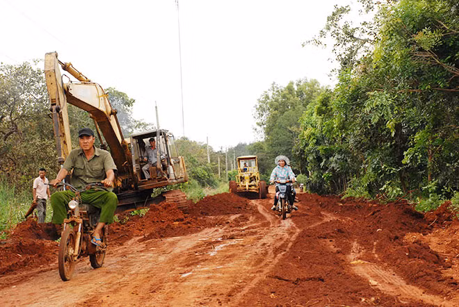 Các phương tiện đang thi công quãng cuối cùng tại ấp 5, xã Nghĩa Trung, huyện Bù Đăng để hoàn thiện đoạn đường.