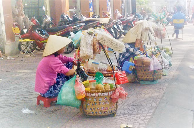 Một người bán thức ăn, nước uống trên vỉa hè để mưu sinh.