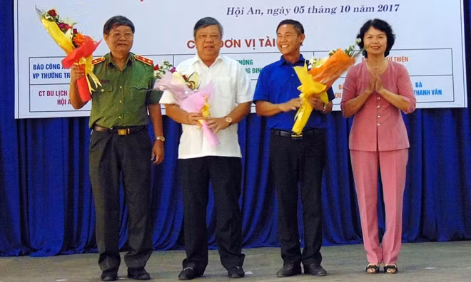 Đại diện Hội Khuyến học Hội An tặng hoa cho Đoàn công tác từ thiện xã hội và lãnh đạo thành phố.