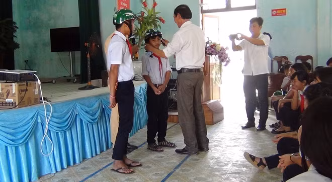 Những em học sinh có câu trả lời đúng được nhận mũ bảo hiểm đạt chuẩn.