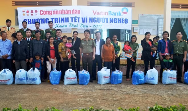 Thượng tá Phạm Khải, Phó Tổng Biên tập Báo CAND, Đại tá Đoàn Quốc Thư, Phó giám đốc Công an tỉnh Đắk Lắk và nhà tài trợ trao quà cho đồng bào nghèo xã Cư Pơng, huyện Rrông Búk.