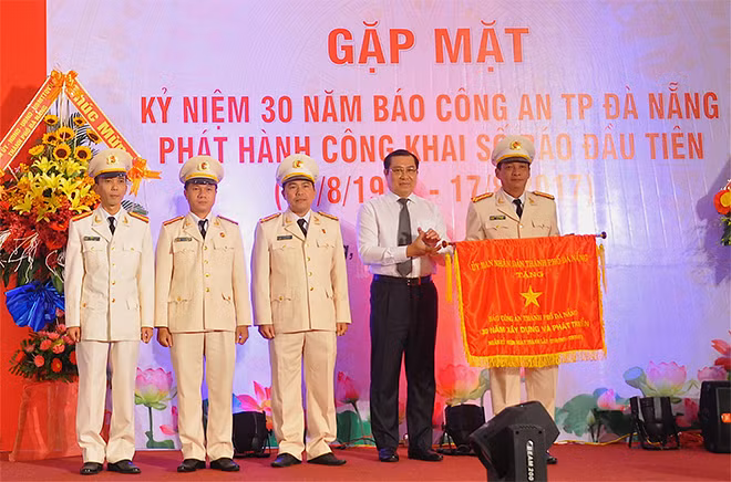 Ông Huỳnh Đức Thơ, Chủ tịch UBND TP Đà Nẵng trao Cờ lưu niệm cho Báo Công an TP Đà Nẵng.