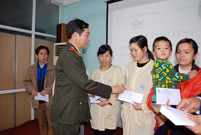 Thiếu tướng Phạm Văn Miên trao quà Tết cho các bệnh nhân nhi và gia đình.