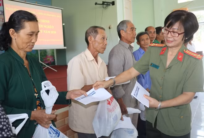Thượng tá Nguyễn Thị Tuyết, Chủ tịch Hội phụ nữ Công an tỉnh Đồng Tháp trao quà cho người dân.