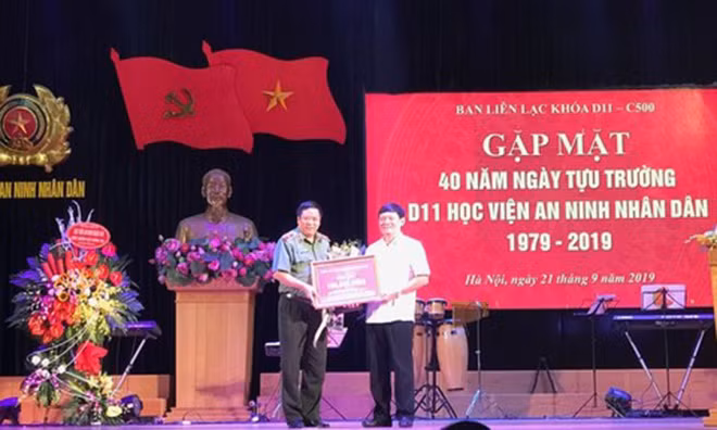 Trung tướng Trần Văn Nhuận (bìa phải) trao số tiền 100 triệu đồng của các cựu sinh viên Khóa 11 ủng hộ Học viện ANND.