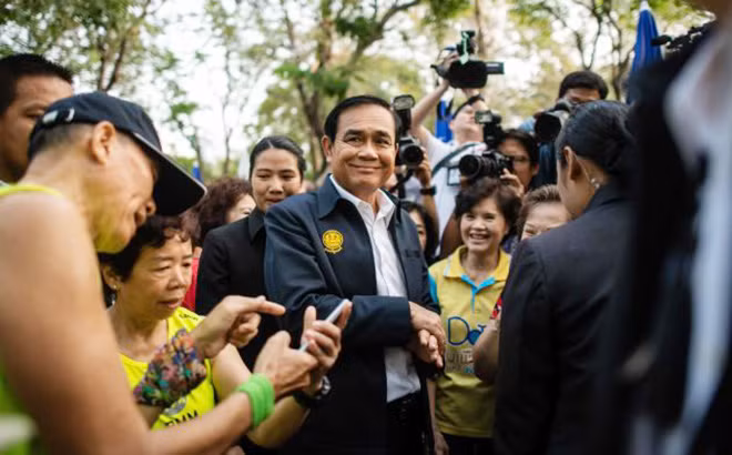 Với kết quả mới được EC công bố chiều 25-3, Thủ tướng Prayuth Chan-o-cha (giữa) đang hy vọng sẽ tiếp tục nắm vị trí cầm quyền thêm nhiệm kỳ nữa. Trong ảnh, ông đang gặp gỡ cử tri ở công viên Lumphini tại thủ đô Bangkok hôm 20-3. Ảnh: Getty