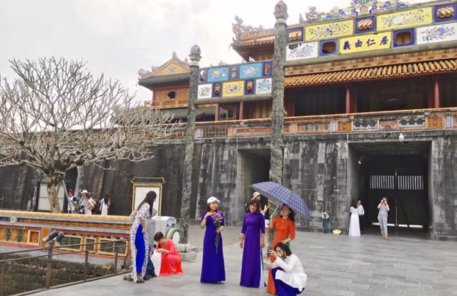 Nữ du khách trong tà áo dài thăm Đại Nội sáng 8-3-2019.
