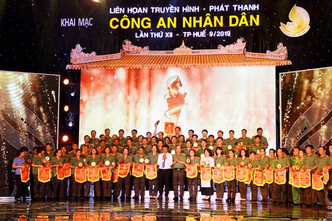 Thượng tướng Nguyễn Văn Thành, Ủy viên Trung ương Đảng, Thứ Trưởng Bộ Công an và đồng chí Trần Bình Minh, Ủy viên Trung ương Đảng, Tổng Giám đốc Đài Truyền hình Việt Nam trao cờ lưu niệm cho các đoàn tham dự liên hoan.