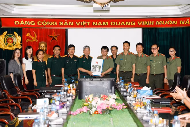 Báo QĐND tặng quà lưu niệm cho Báo CAND.