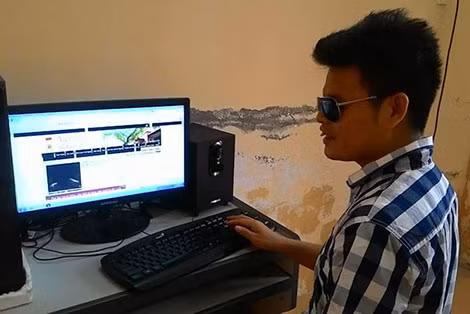 Lê Trung Cường bên chiếc máy tính ngồi viết văn.