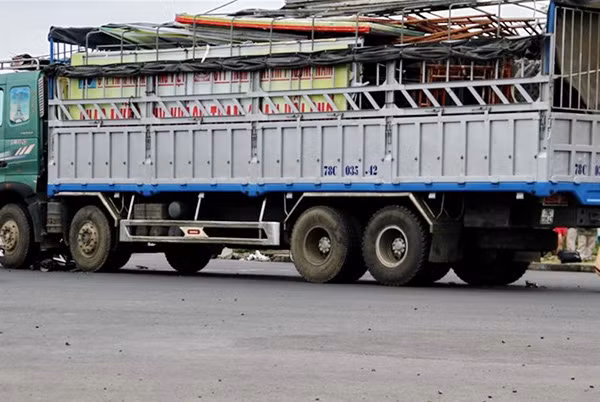 Chiếc xe máy bẹp dúm dưới gầm xe tải.