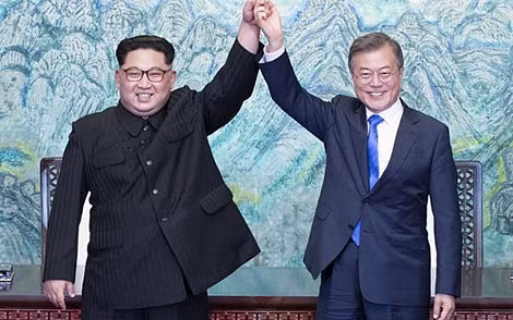 Nhà lãnh đạo Triều Tiên Kim Jong-un và Tổng thống Hàn Quốc Moon Jae-in cùng giơ tay sau khi ký Tuyên bố chung. Ảnh: Reuters.