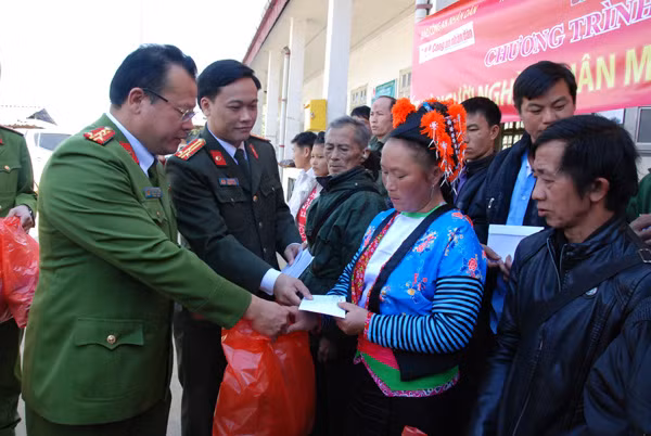 Đại diện Báo CAND cùng lãnh đạo Công an huyện Tuần Giáo trao quà Tết tới đồng bào nghèo xã Pú Xi.