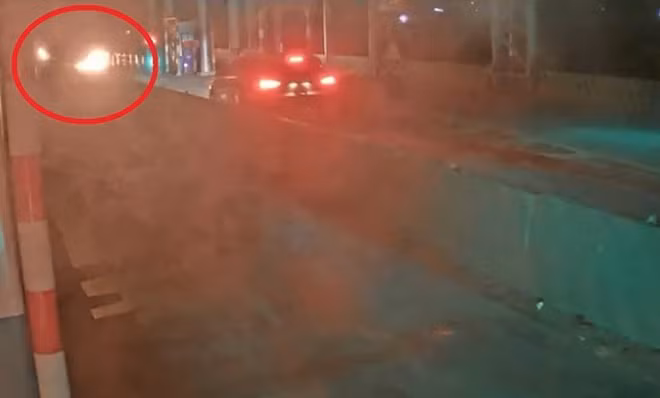 Một xe ôtô du lịch dừng lại khi “bom xăng” bốc cháy trong làn thu phí số 3. (Ảnh cắt từ clip do camera Trạm BOT Ninh Xuân ghi lại)