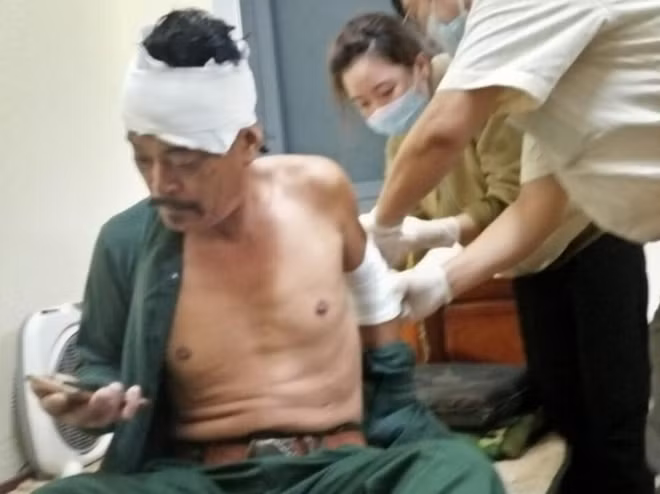 Y, bác sĩ băng bó vết thương cho thuyền viên sau khi được cứu hộ vào bờ an toàn.