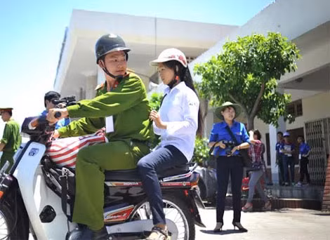 Một cán bộ Công an Hà Nôi chở thí sinh đến địa điểm thi.