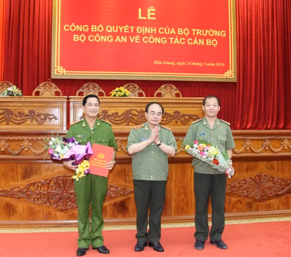 Thứ trưởng Bùi Quang Bền tặng hoa cho Đại tá Nguyễn Hải Sơn, Phó Tổng cục trưởng Tổng cục V và trao quyết định cho Đại tá Phan Hoàng Lắm, Giám đốc Công an Hậu Giang.