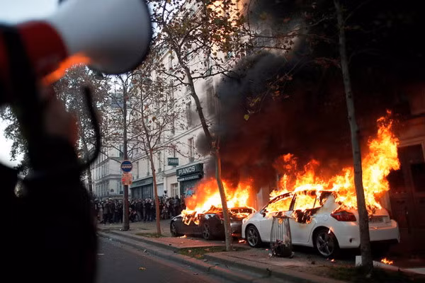 Những người biểu tình quá khích đốt phá xe hơi trên đường phố Paris. Ảnh: EPA