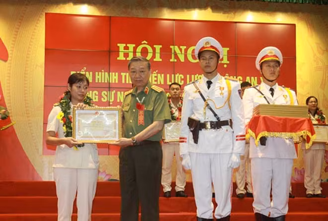 Bộ trưởng Tô Lâm trao Bằng khen của Bộ Công an tặng đồng chí nữ trưởng Công an xã.