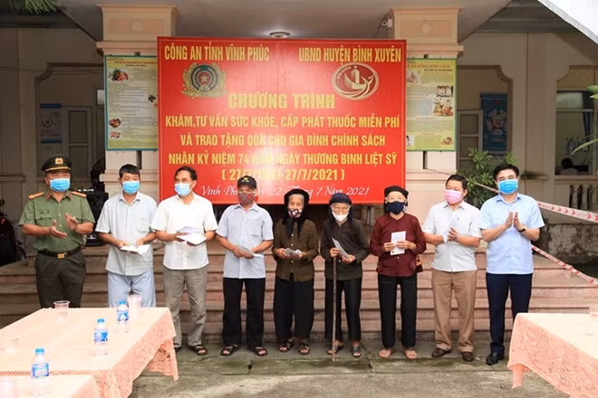 Bí thư Huyện ủy Bình Xuyên và đại diện lãnh đạo Công an tỉnh trao quà tặng các gia đình chính sách.