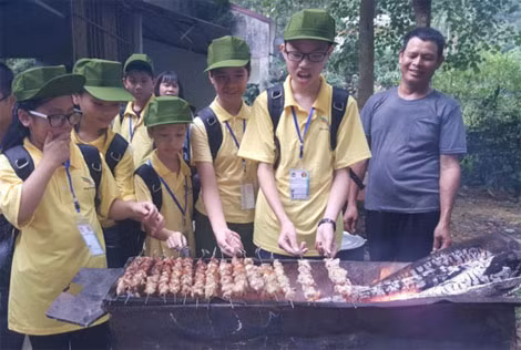 Các chiến sĩ nhí trổ tài nấu cơm bằng bếp củi, nướng thịt và cùng nhau thưởng thức.